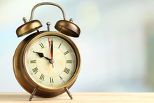 Old Alarm Clock  On Bright Background