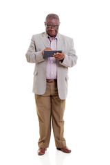 Wall Mural - senior african man using tablet computer