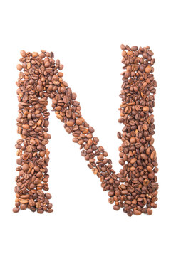 Letter N, alphabet from coffee beans on white background