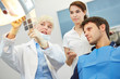 © Robert Kneschke - Dentist showing caries on x-ray image
