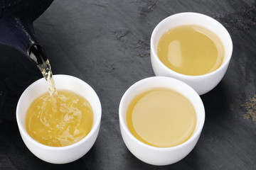 Sticker - Green tea being poured into cups