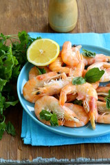 Sticker - shrimp cooked with lemon and basil on a wooden table