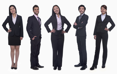 portrait of five young smiling businesswomen and young businessmen, looking at camera, studio shot