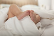 © xixinxing - Close-up of baby's feet in the blanket