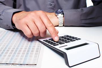 Aufkleber - Hand of a businessman with calculator.