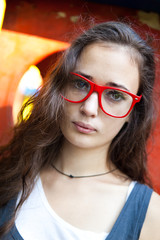 Wall Mural - Young woman with red glasses in the park