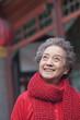 © xixinxing - Portrait of senior woman outside a traditional Chinese building