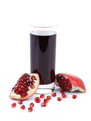 Wall Mural - Glass of pomegranate juice with sliced fruits