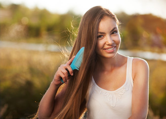 beautiful girl combs her hair Asian appearance