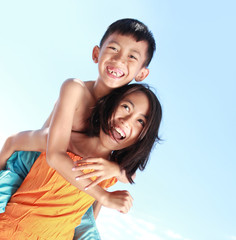 Wall Mural - Happy kids having fun doing piggyback ride