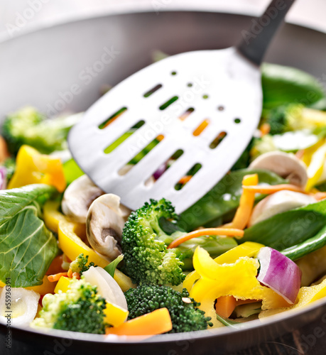 Cuadros en Lienzo vegetarian wok stir fry with metal spatula.
