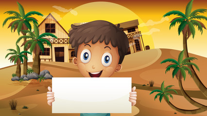 Wall Mural - A smiling boy at the desert with an empty signage