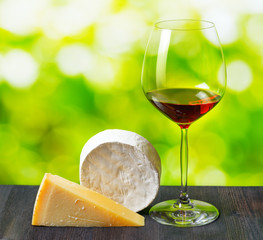 Canvas Print - Cheese and glass of wine on nature background