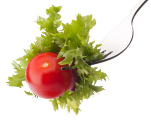 Fresh salad and cherry tomato on fork isolated on white backgrou