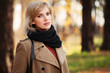 © Wrangler - Happy blond woman in autumn forest
