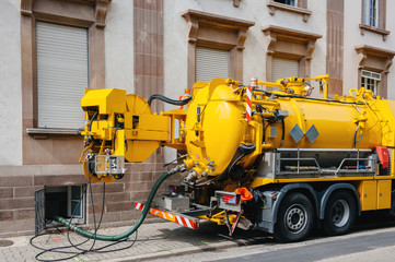 Sewerage truck on city street working