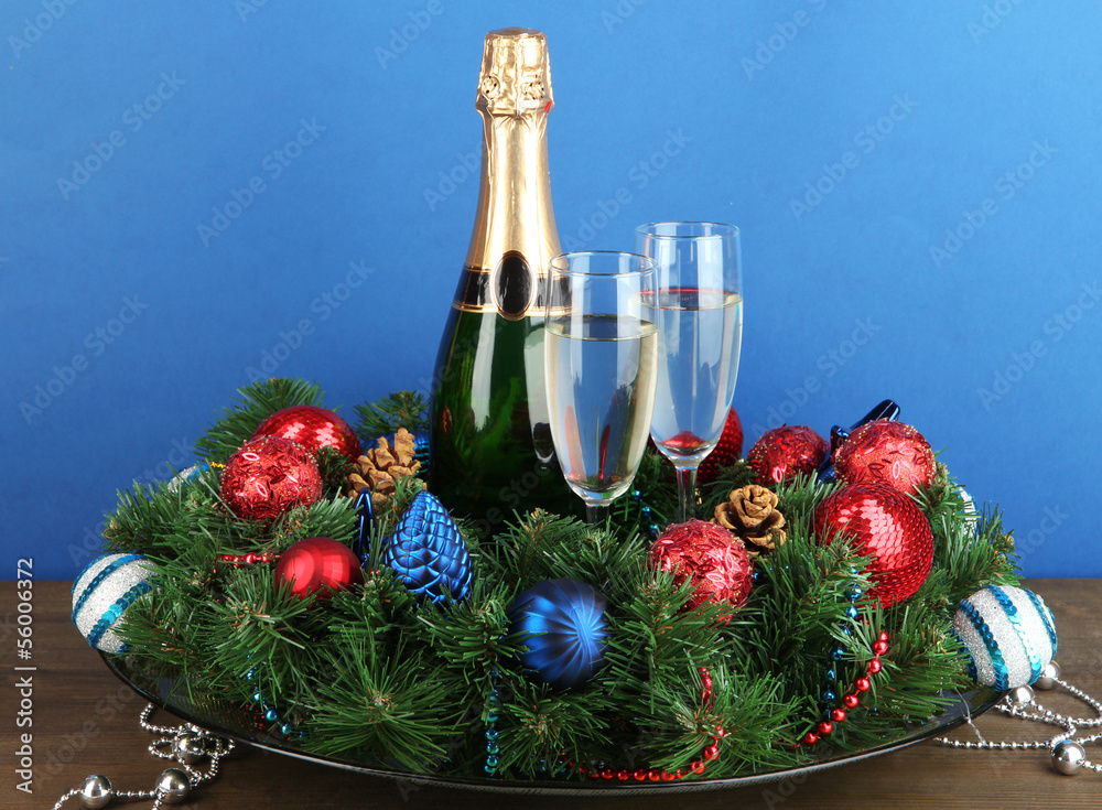 Beautiful Christmas wreath in composition with champagne