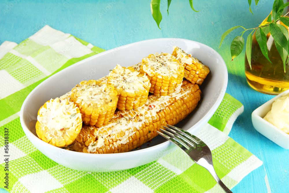 Flavored boiled corn on  plate on wooden table close-up