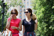 Two young women walking in the summer city
