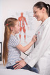 © BlueSkyImages - Doctor and little girl. Cheerful little girl examining doctor wi