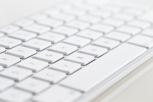 A Close-up Of A White Computer Keyboard On A White Background