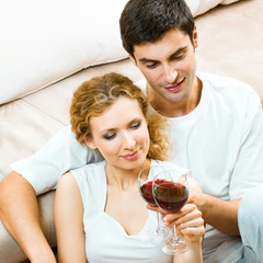 Canvas Print - Cheerful couple with glasses of redwine