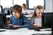 © Tyler Olson - Schoolchildren Using Desktop Pc In Computer Lab