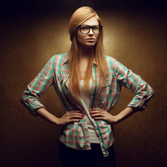 Wall Mural - Portrait of a young beautiful red-haired wearing trendy glasses