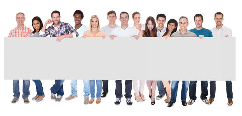 Wall Mural - Group of business people with a blank banner