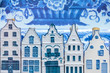 Dutch Delft blue souvenir houses in front of an old plate