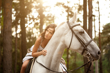 Young woman on a horse. Horseback rider, woman riding horse