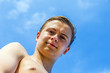 © travelview - handsome confident teenager at the beach with wet hair after swi