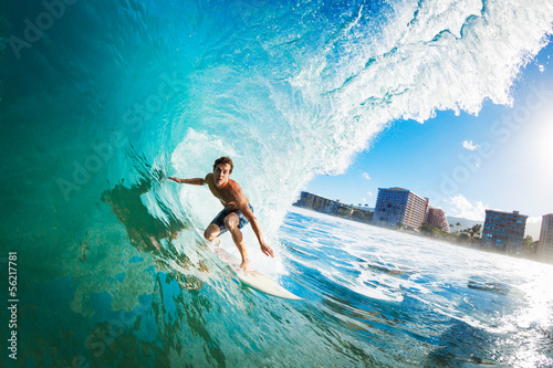 Surfer on Blue Ocean Wave in the Tube Getting Barreled