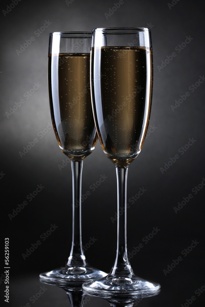 two glasses of champagne on grey background