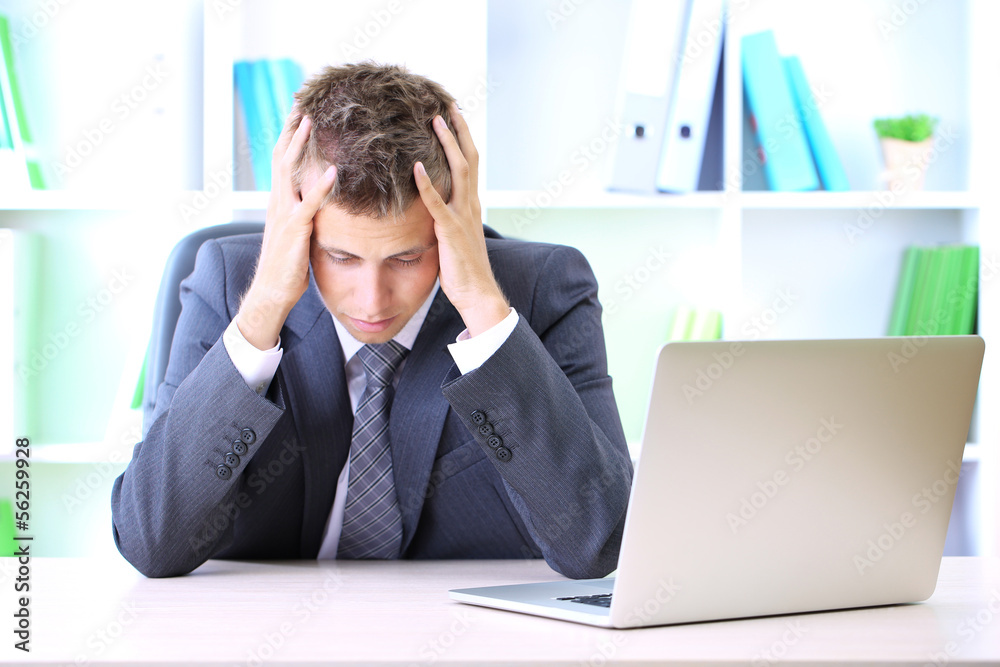 Portrait of young businessman working in office