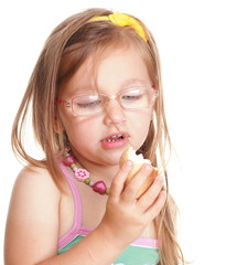 Wall Mural - Funny little girl in glasses eating bread doing fun isolated