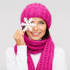 Wall Mural - woman in hat and muffler with big snowflake