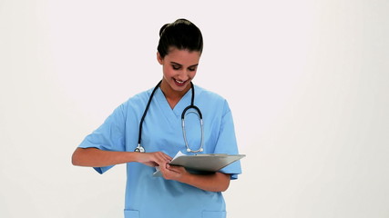 Wall Mural - Cheerful beautiful nurse filling a report