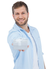 Poster - Portrait of smiling young model offering gift