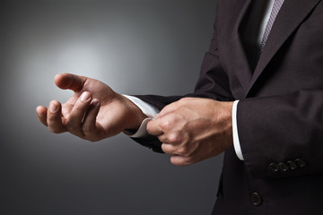 Close-up of elegance man hands with cufflink