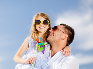 Poster - happy father and child in sunglasses over blue sky