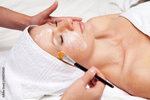 Fotografie, Obraz Spa therapy for woman receiving facial mask at beauty salon