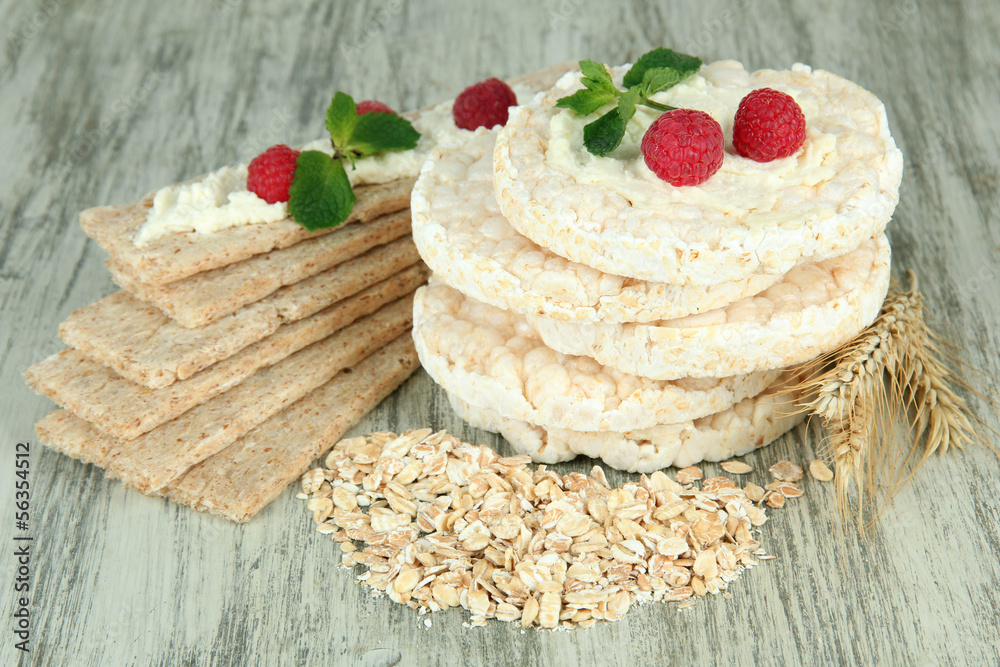 Tasty crispbread with berries, on wooden table