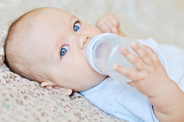 Wall Mural - baby drinking water