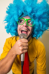 Wall Mural - crazy funny young man with blue wig