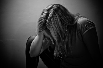 Wall Mural - sad woman sitting alone in a empty room