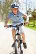 © Monkey Business - Young Boy Riding Bike Along Country Track