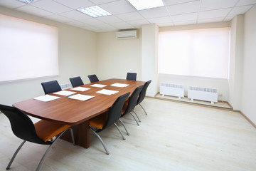 Wall Mural - Empty lighting meeting room with long table with papers