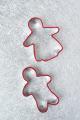 two baking dish in the form of little men on a silver background