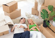 couple relaxing in the middle of boxes